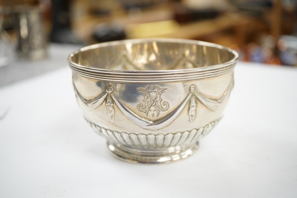 Two Victorian silver sugar bowls, a Victorian silver gilt sifter ladle and a repousse silver dish, 11.8oz. Condition - fair to good